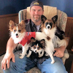 JAKE WITH 3 DOGS ON HIS LAP